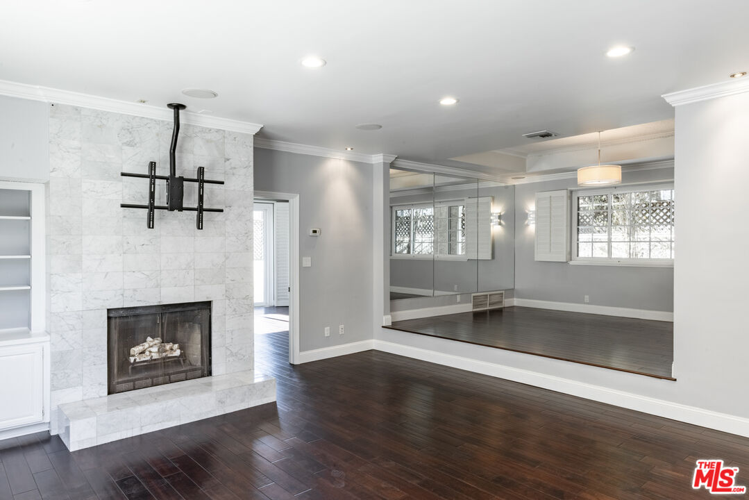 818 6th Street, Unit 102 Santa Monica, CA 90403 - Photo 11 of 29 an empty room with wooden floor fireplace and windows