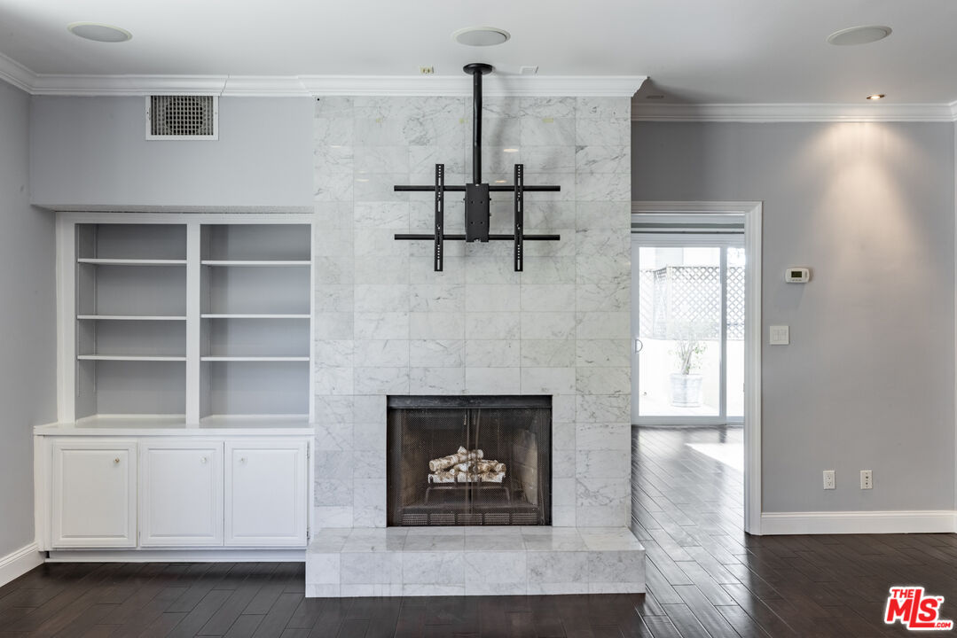 818 6th Street, Unit 102 Santa Monica, CA 90403 - Photo 12 of 29 a living room with furniture and a fireplace