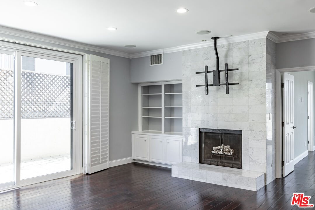 818 6th Street, Unit 102 Santa Monica, CA 90403 - Photo 13 of 29 a view of empty room with a fireplace and wooden floor