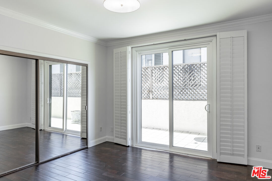 818 6th Street, Unit 102 Santa Monica, CA 90403 - Photo 14 of 29 a view of an empty room with wooden floor and a window