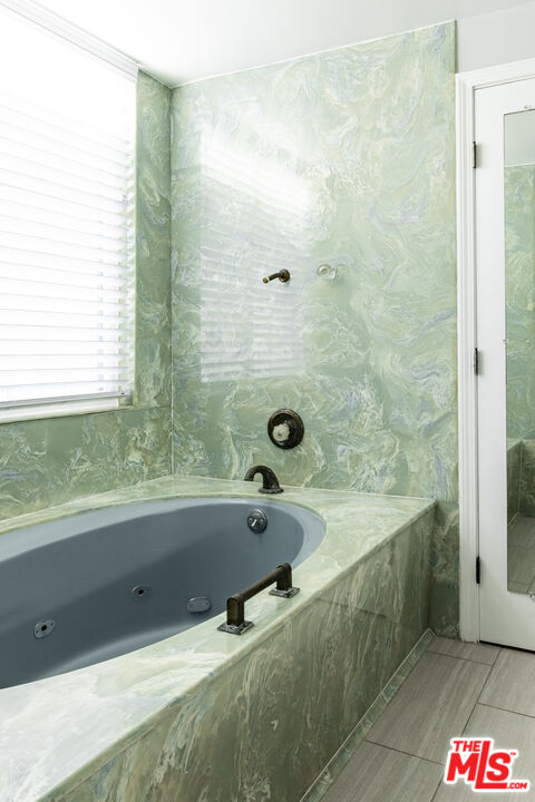 818 6th Street, Unit 102 Santa Monica, CA 90403 - Photo 23 of 29 a bathroom with a bathtub and a shower