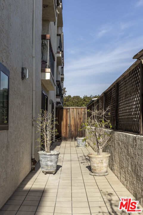 818 6th Street, Unit 102 Santa Monica, CA 90403 - Photo 27 of 29 a terrace with outdoor seating and wooden floor