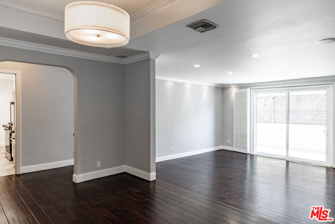 818 6th Street, Unit 102 Santa Monica, CA 90403 - Photo 8 of 29 an empty room with wooden floor and windows