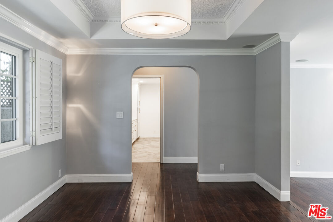 818 6th Street, Unit 102 Santa Monica, CA 90403 - Photo 9 of 29 an empty room with wooden floor and windows