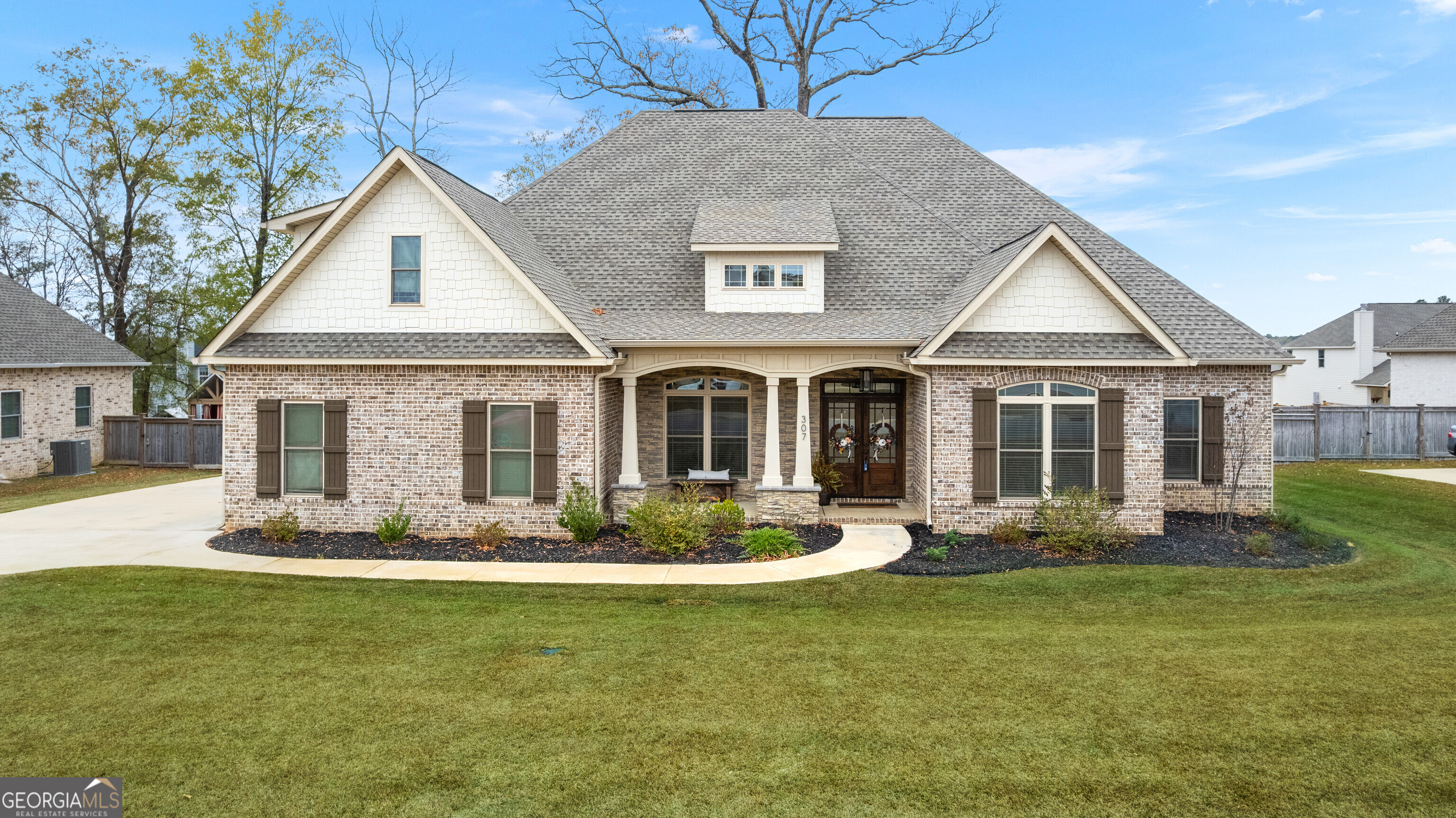 a front view of a house with a yard