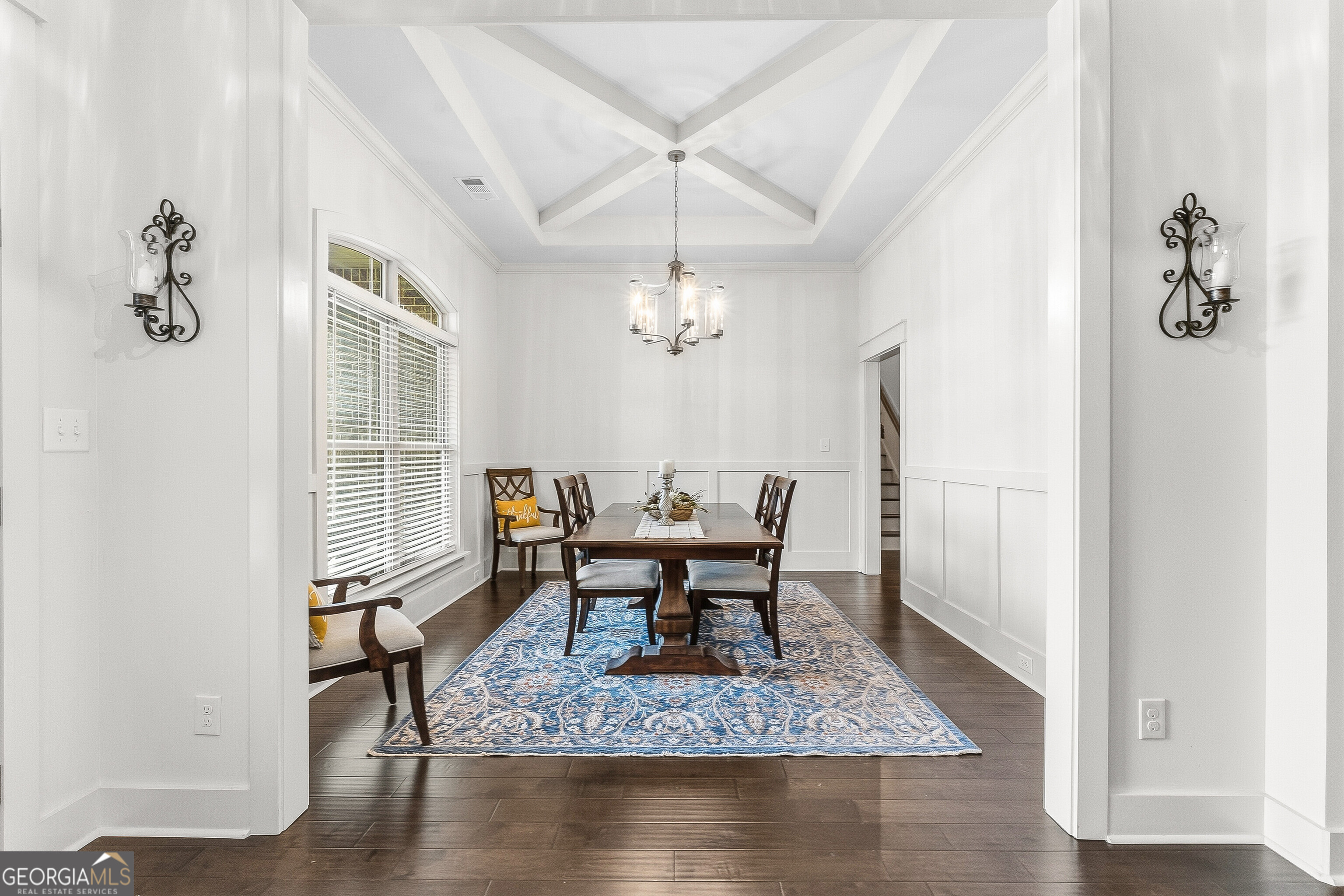 307 Apalachee Way Bonaire, GA 31005 - Photo 11 of 61 a dining room with wooden floor a chandelier a wooden table and chairs