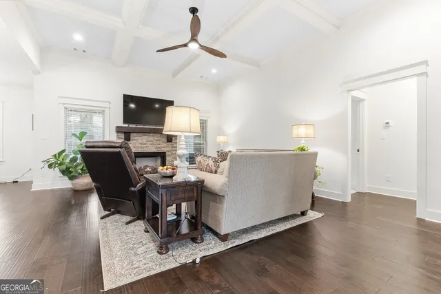 a living room with furniture and a view of kitchen