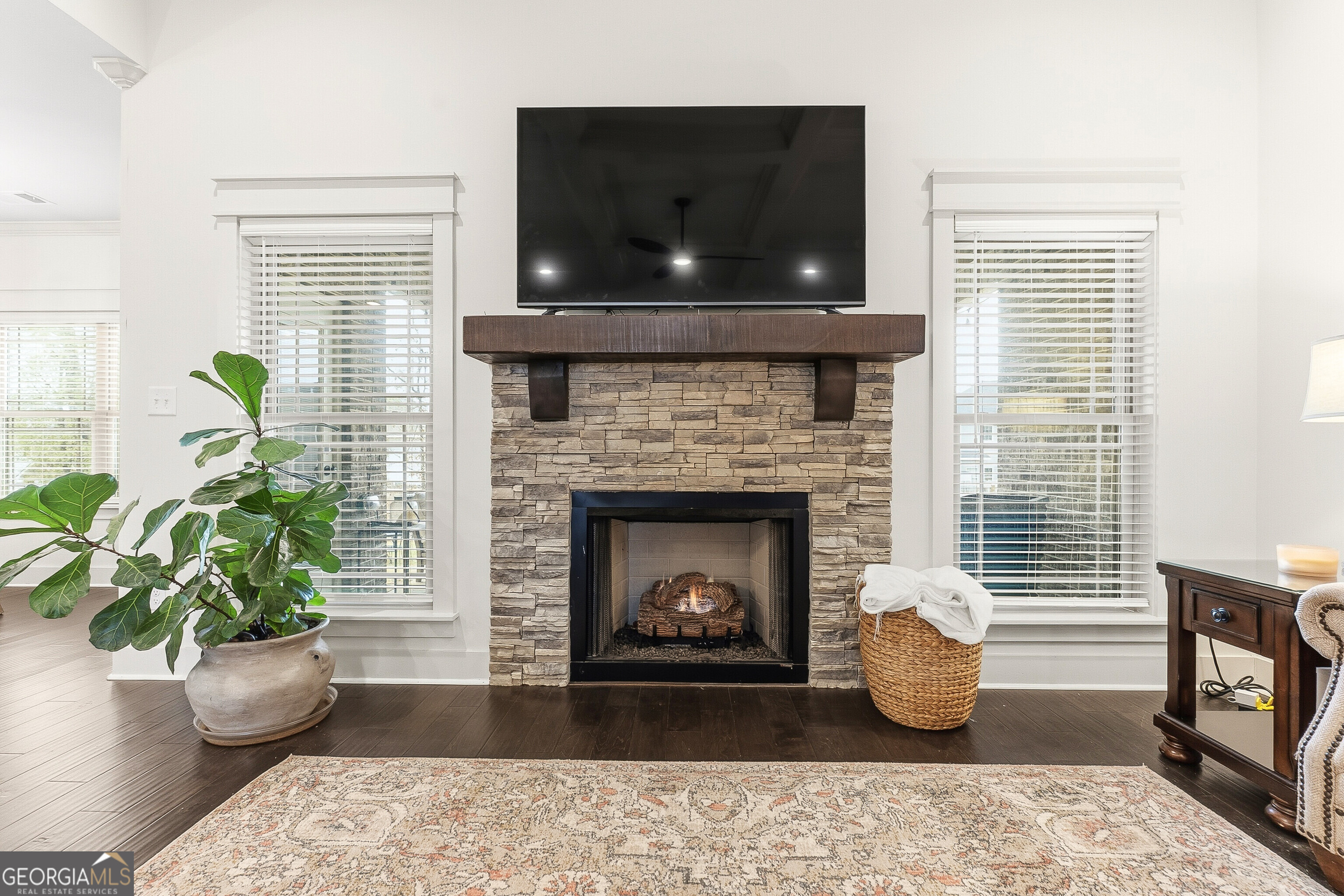 307 Apalachee Way Bonaire, GA 31005 - Photo 15 of 61 a living room with a fireplace and wooden floor