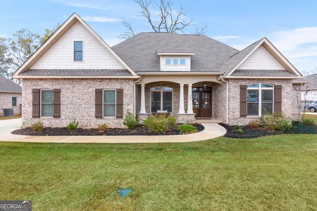 a front view of a house with a yard and garage