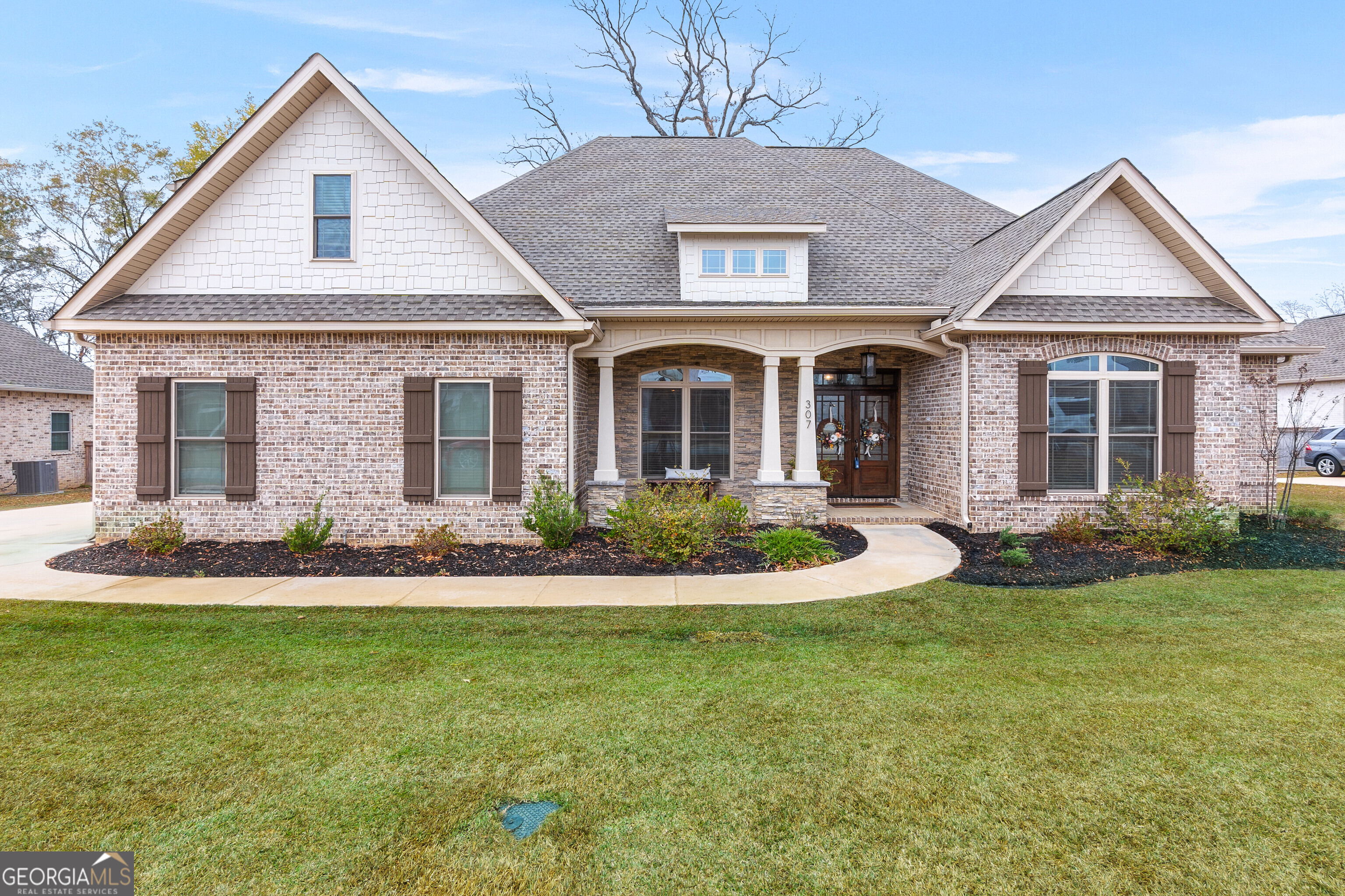 307 Apalachee Way Bonaire, GA 31005 - Photo 2 of 61 a front view of a house with a yard and garage
