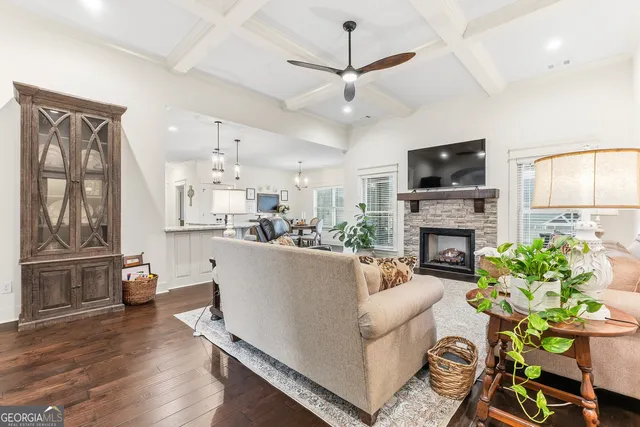 a kitchen with stainless steel appliances a stove a sink a refrigerator and white cabinets