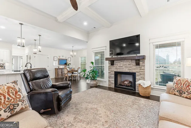 a kitchen with stainless steel appliances white cabinets and wooden floors