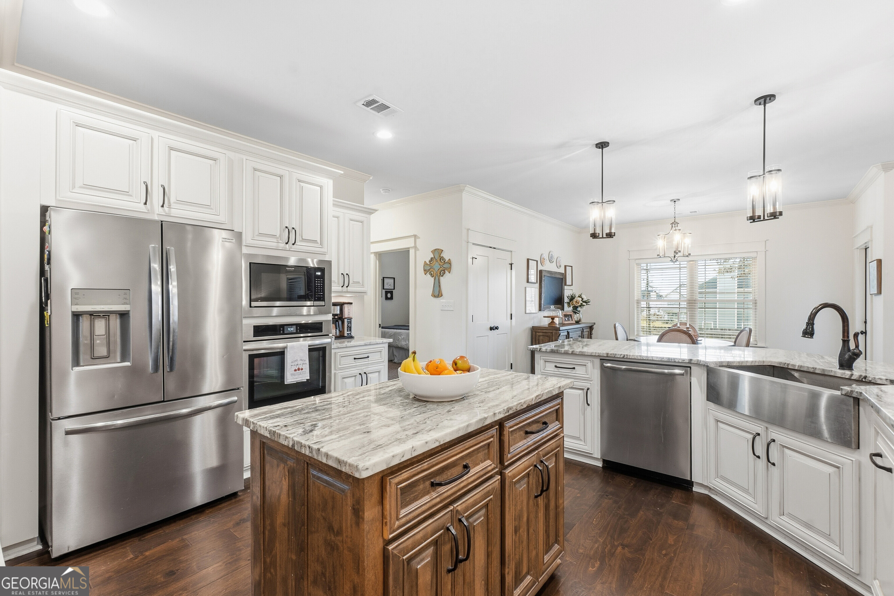307 Apalachee Way Bonaire, GA 31005 - Photo 26 of 61 a kitchen with stainless steel appliances a stove a sink a refrigerator and white cabinets