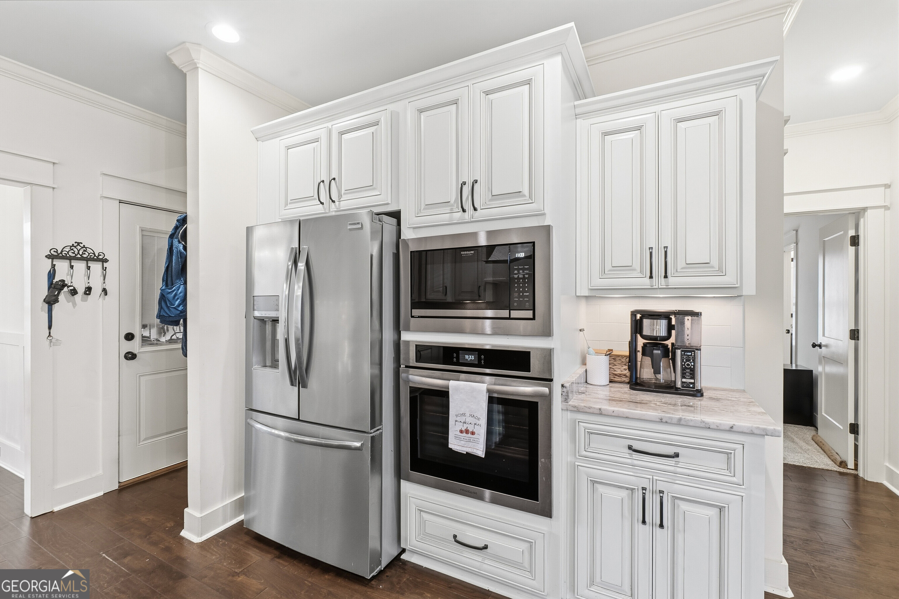 307 Apalachee Way Bonaire, GA 31005 - Photo 27 of 61 a kitchen with stainless steel appliances white cabinets and wooden floors