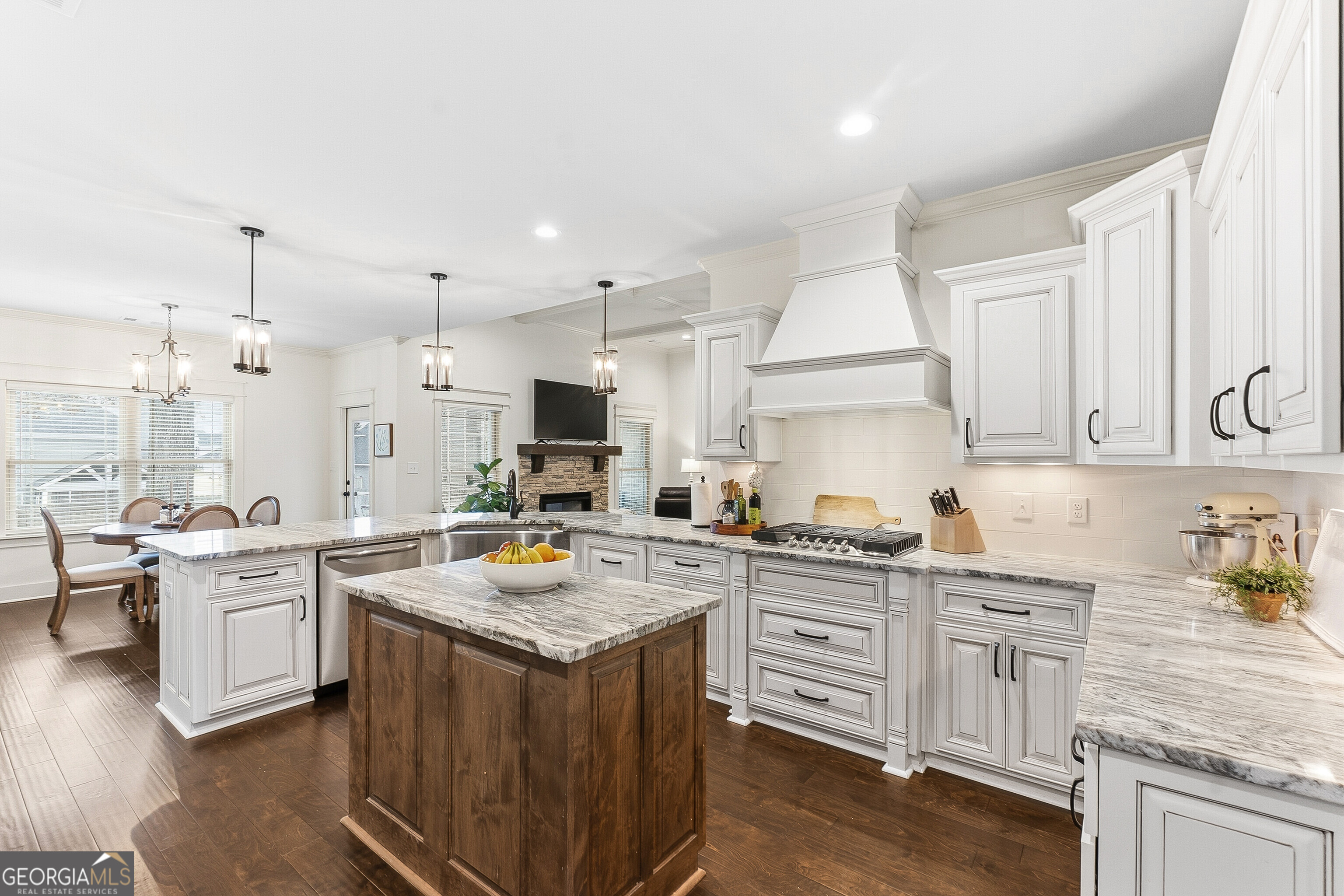 307 Apalachee Way Bonaire, GA 31005 - Photo 28 of 61 a kitchen with stainless steel appliances granite countertop a stove top oven a sink dishwasher and white cabinets with wooden floor