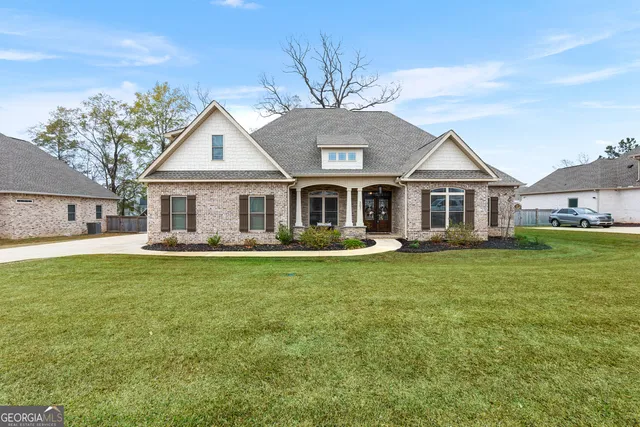 a front view of a house with a garden