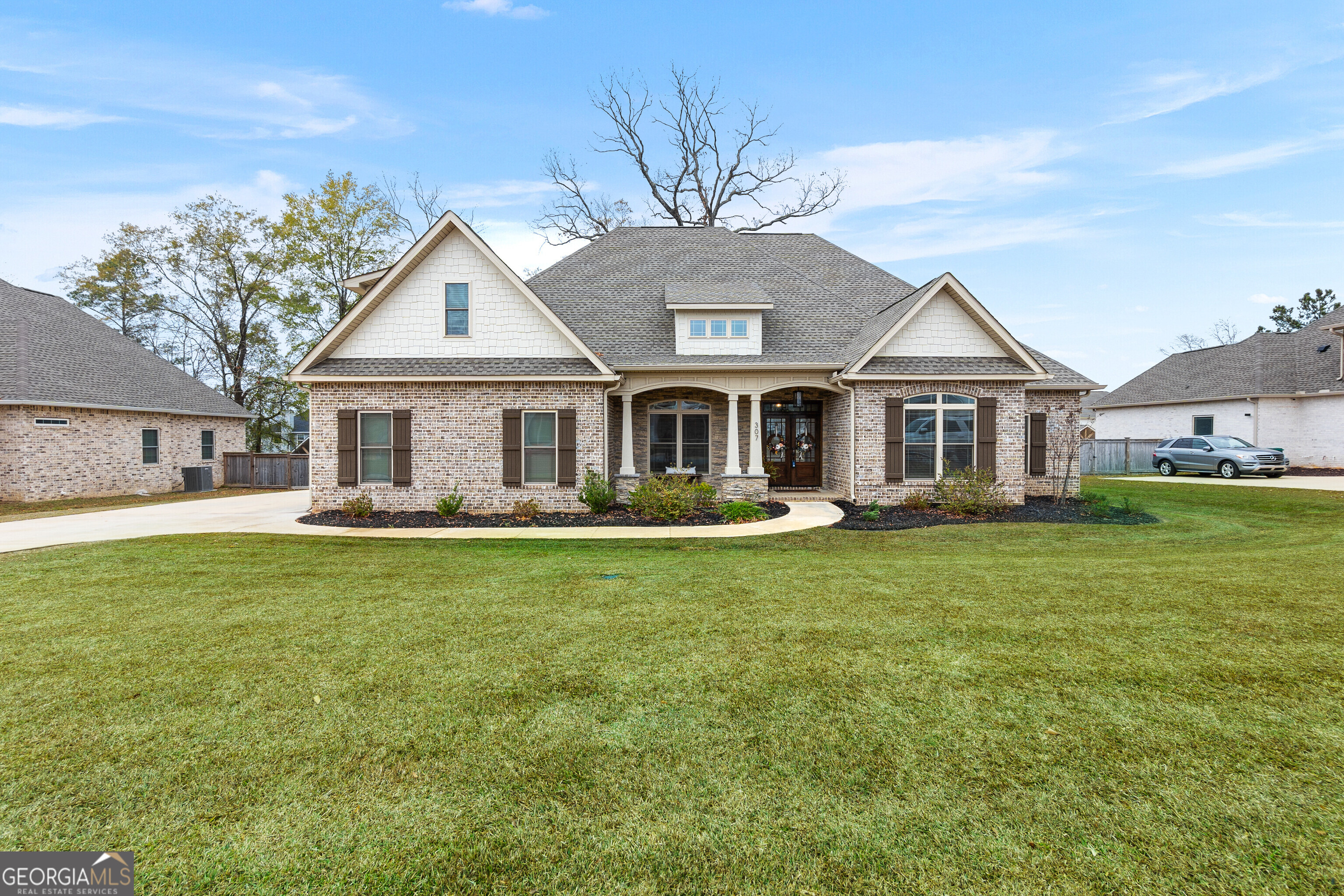 307 Apalachee Way Bonaire, GA 31005 - Photo 3 of 61 a front view of a house with a garden