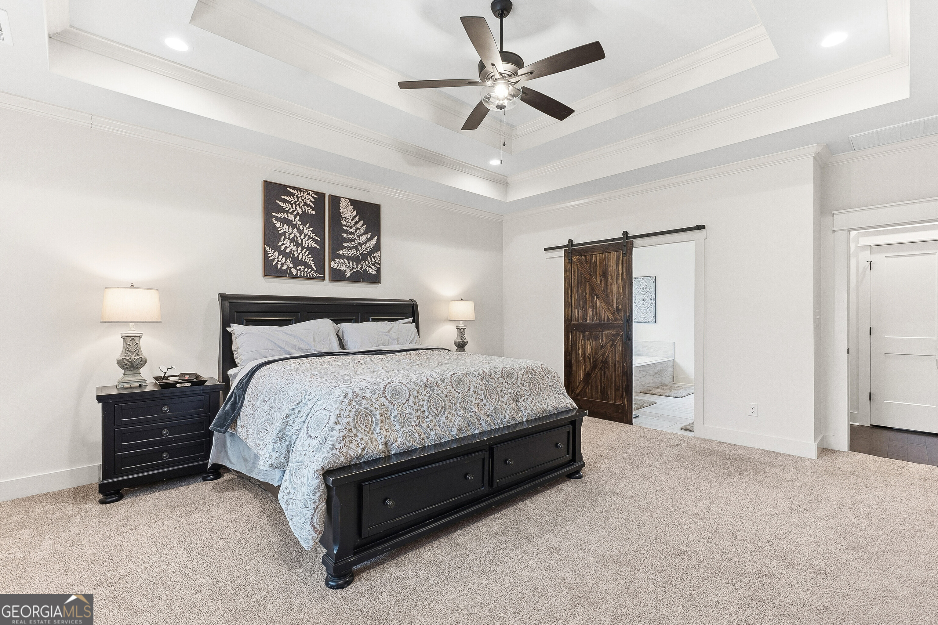 307 Apalachee Way Bonaire, GA 31005 - Photo 31 of 61 a spacious bedroom with a bed and a lamp