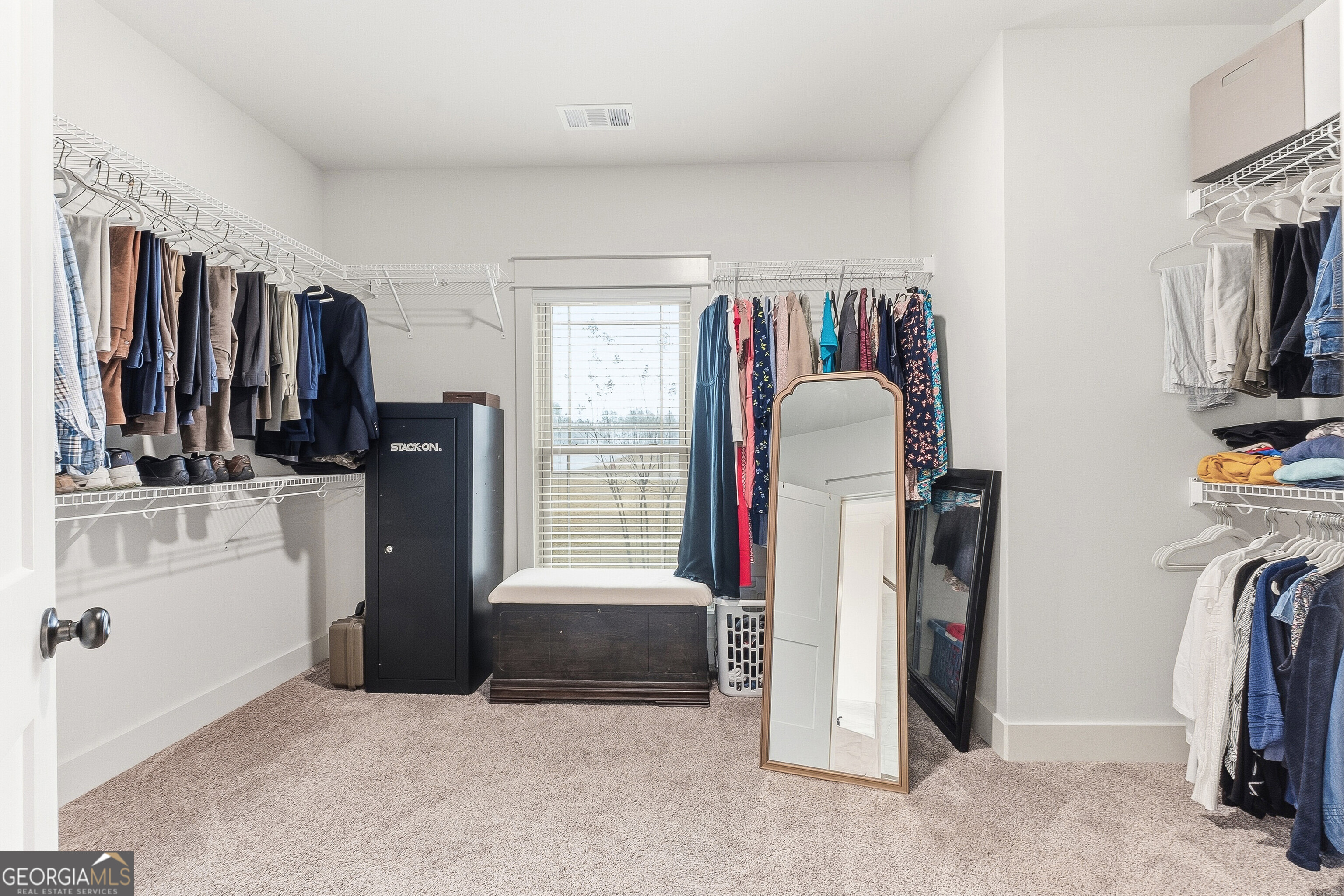 307 Apalachee Way Bonaire, GA 31005 - Photo 40 of 61 a view of walk in closet with clothes