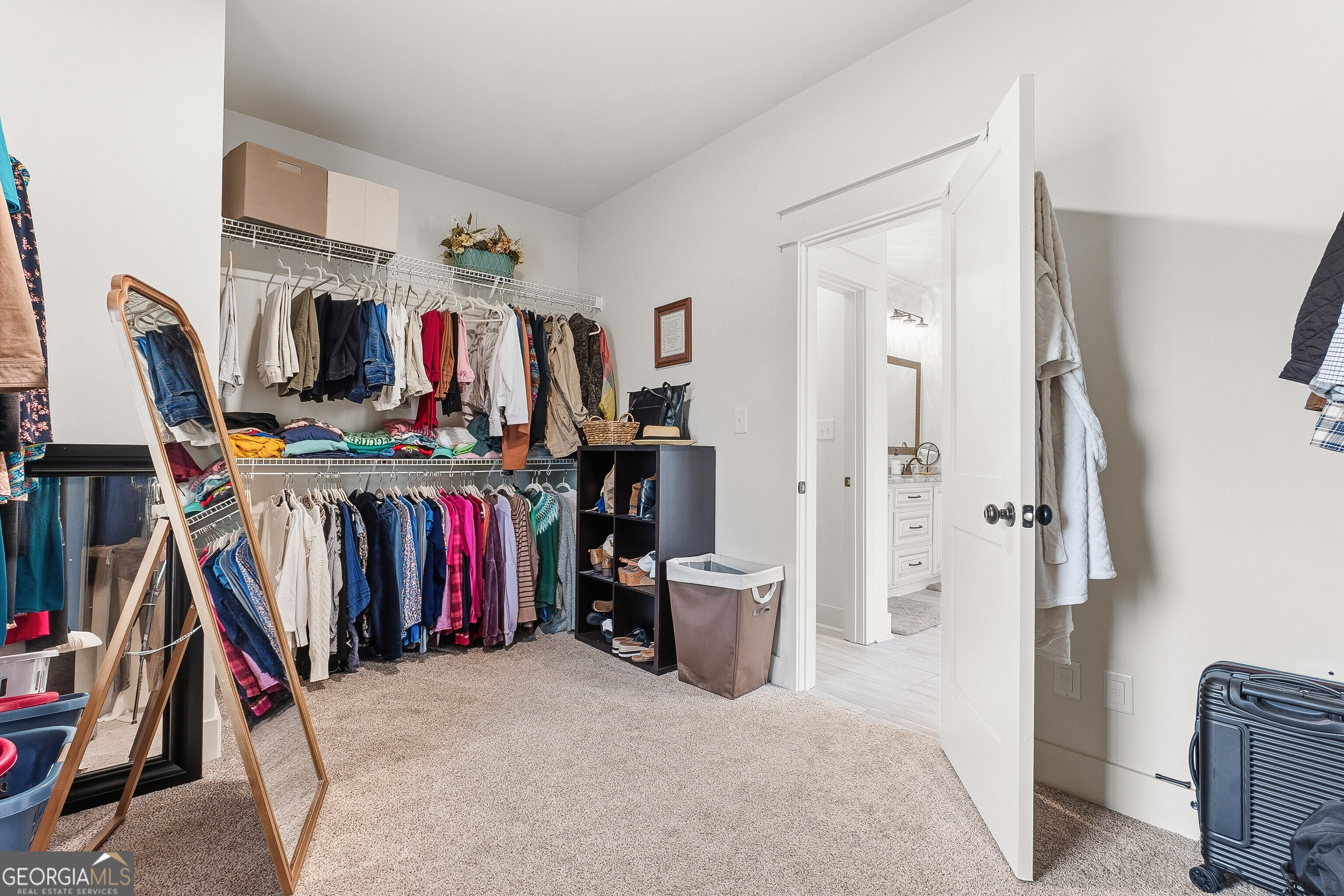 307 Apalachee Way Bonaire, GA 31005 - Photo 41 of 61 a view of walk in closet with clothes and shoes
