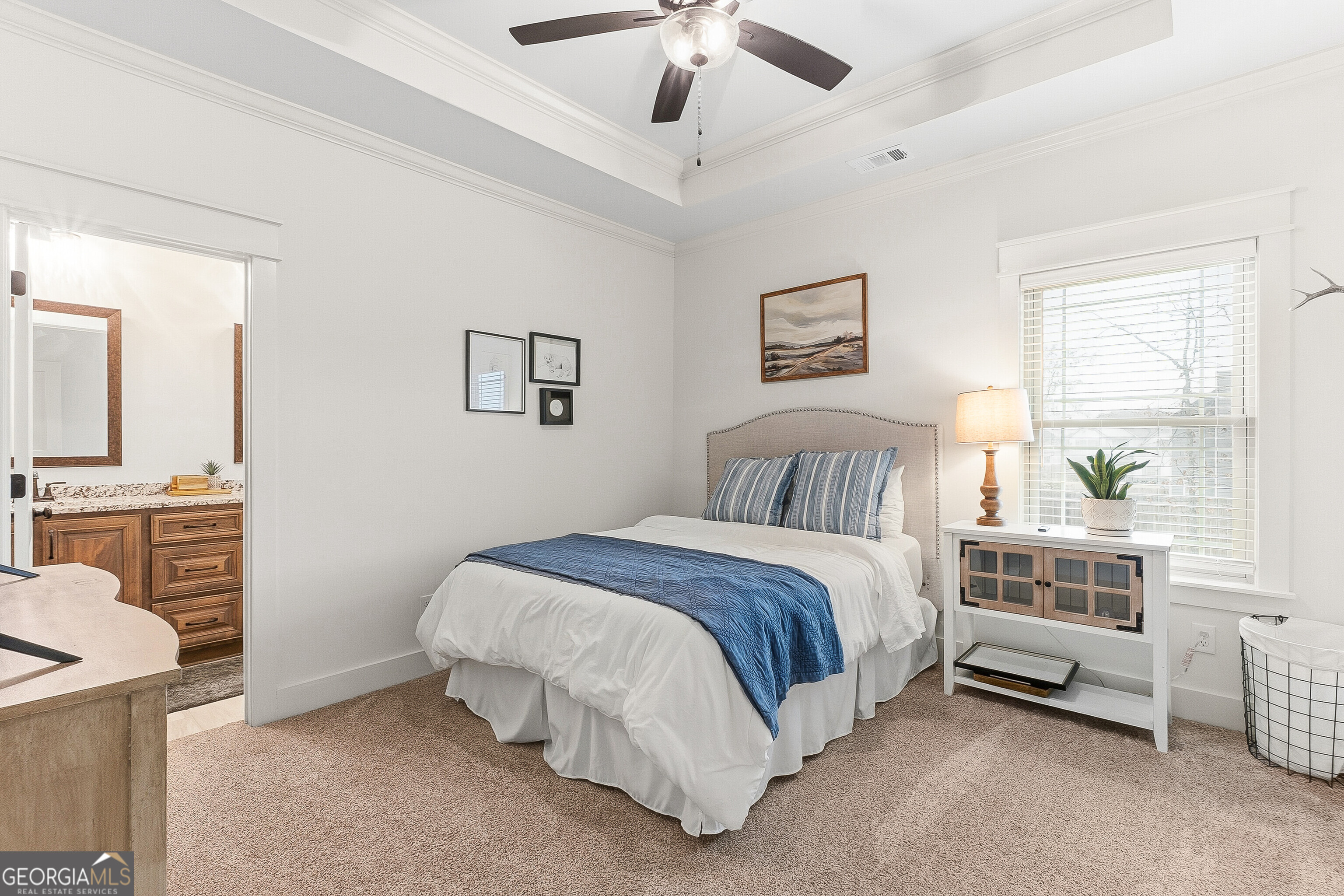 307 Apalachee Way Bonaire, GA 31005 - Photo 42 of 61 a spacious bedroom with a bed and a chandelier