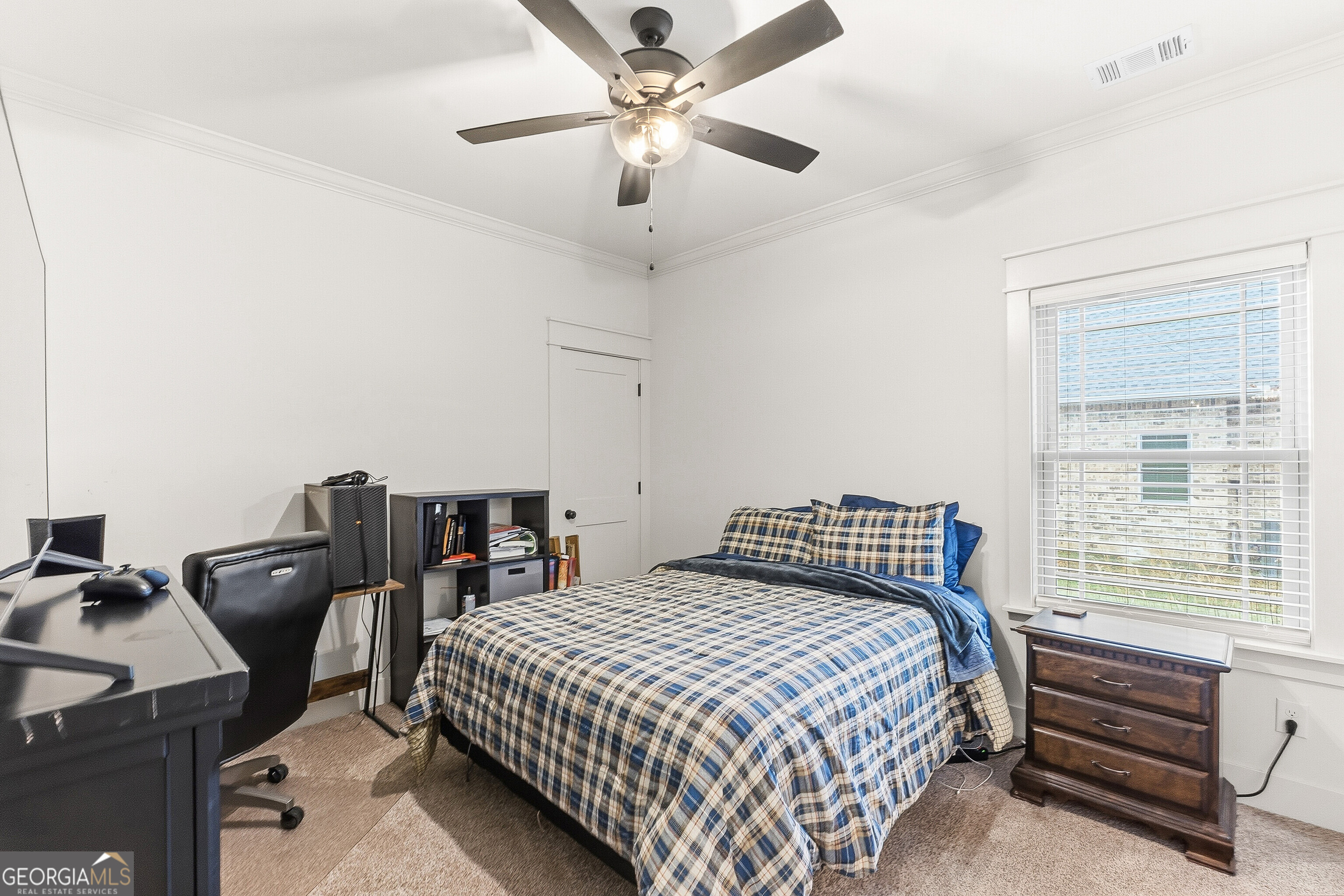 307 Apalachee Way Bonaire, GA 31005 - Photo 45 of 61 a bedroom with a bed and a chandelier