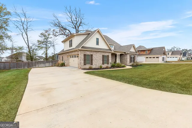 a front view of house with yard and green space