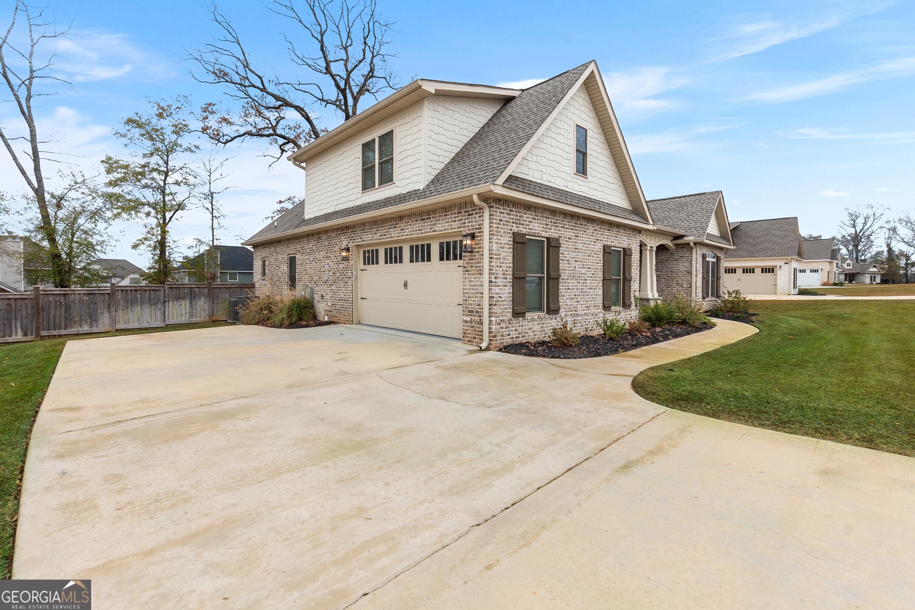 307 Apalachee Way Bonaire, GA 31005 - Photo 6 of 61 a view of a white house with a yard