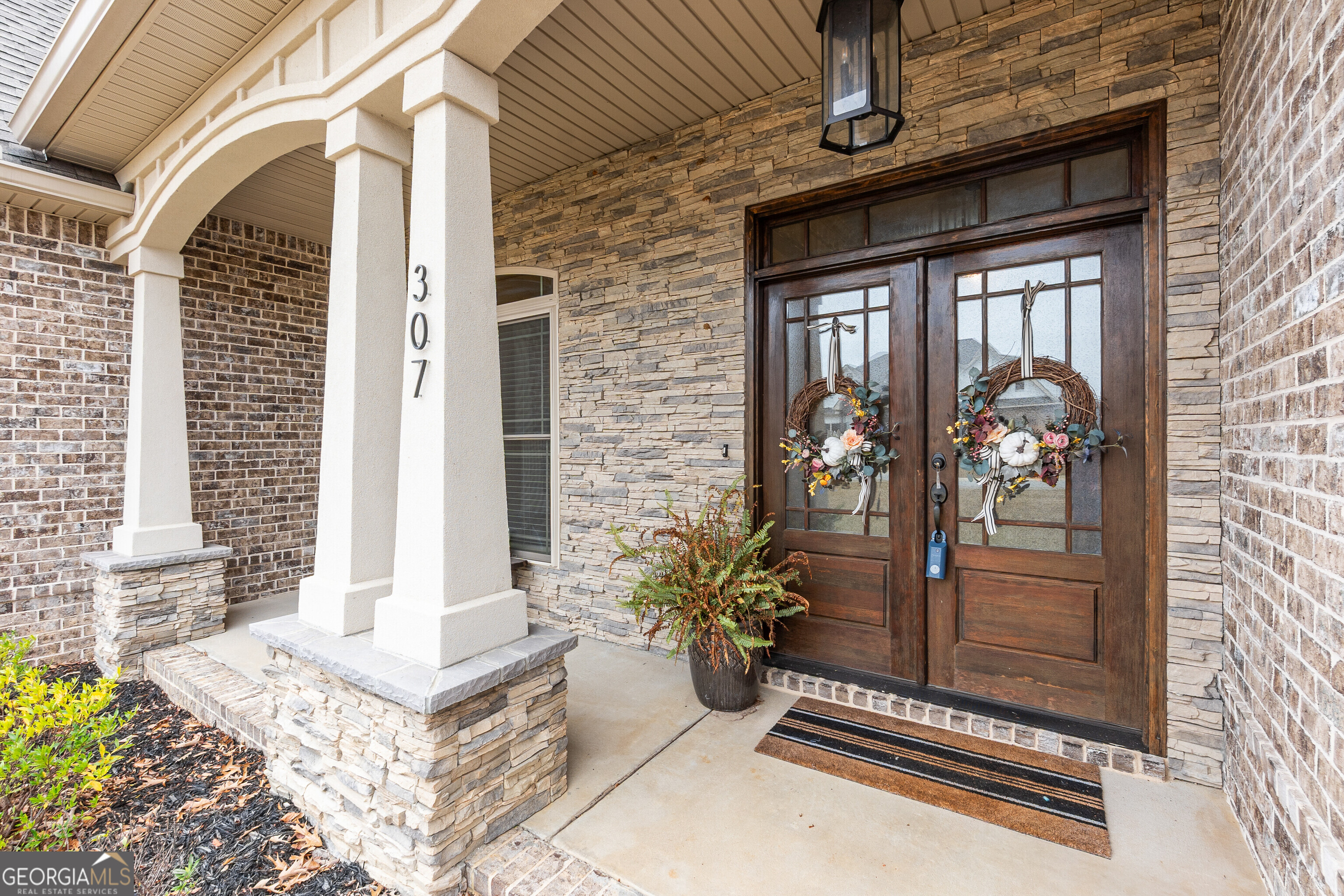 307 Apalachee Way Bonaire, GA 31005 - Photo 7 of 61 a front view of a house with a porch