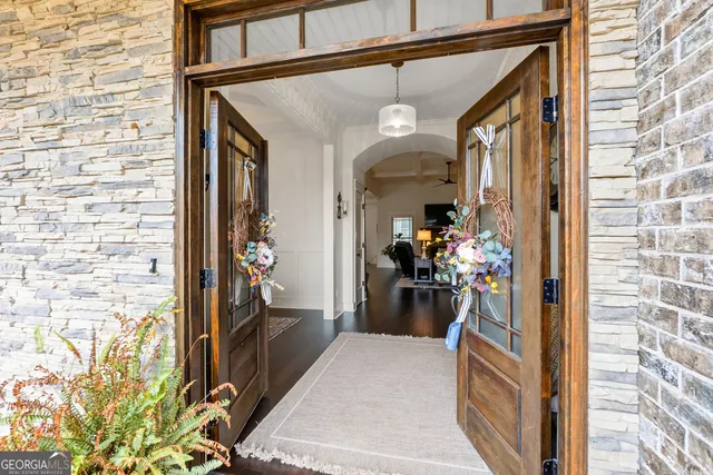 a dining room with furniture entryway and wooden floor