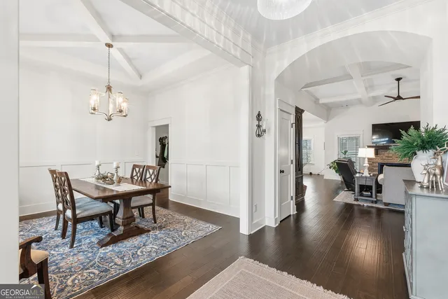 a view of a dining room with furniture a rug and wooden floor