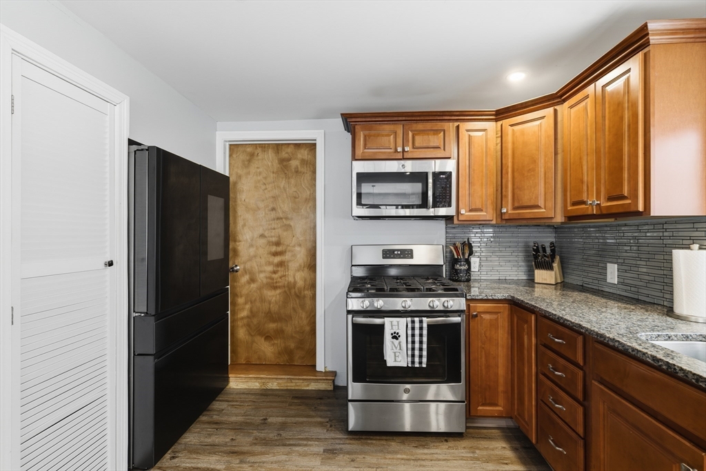 10 Aberdeen Street Fall River, MA 02721 - Photo 11 of 35 a kitchen with stainless steel appliances granite countertop a stove a sink and a refrigerator