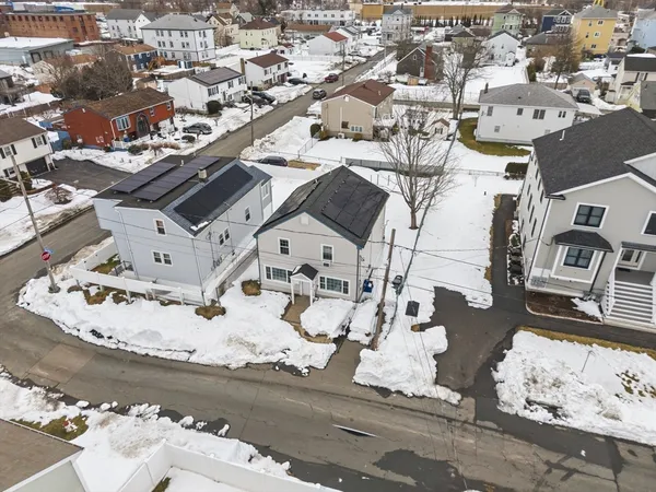 an aerial view of a house with a snow