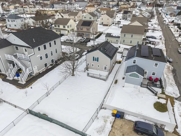 an aerial view of a house with swimming pool and sitting space