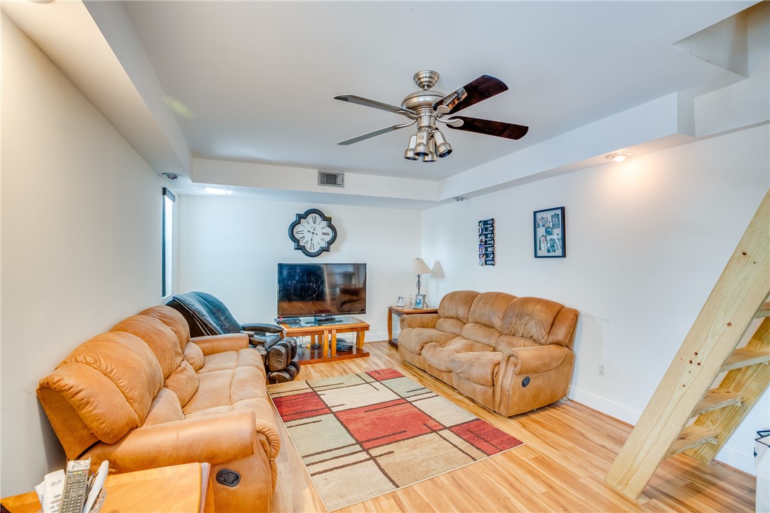 474 Azine Terrace Sebastian, FL 32958 - Photo 15 of 33 a living room with furniture a clock on the wall and a table