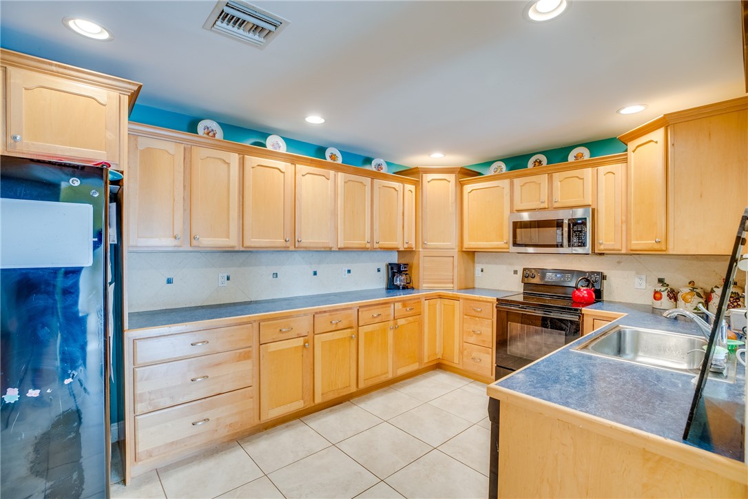 474 Azine Terrace Sebastian, FL 32958 - Photo 10 of 33 a kitchen with granite countertop cabinets stainless steel appliances a sink and a window