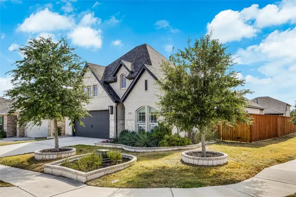 a view of a house with backyard fountain and a tree