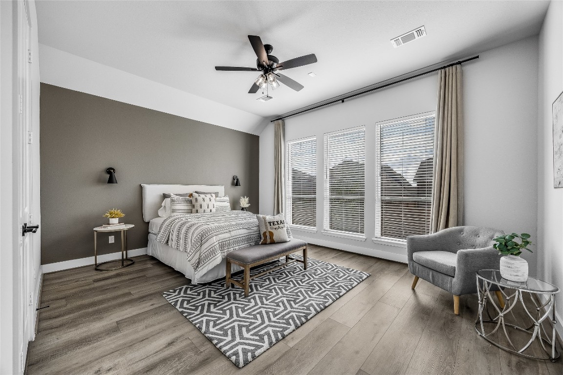 200 Grn Knl Lane Georgetown, TX 78628 - Photo 14 of 32 a bedroom with wooden floor and a ceiling fan