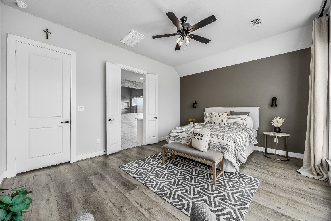 200 Grn Knl Lane Georgetown, TX 78628 - Photo 15 of 32 a bedroom with a large bed and a chandelier