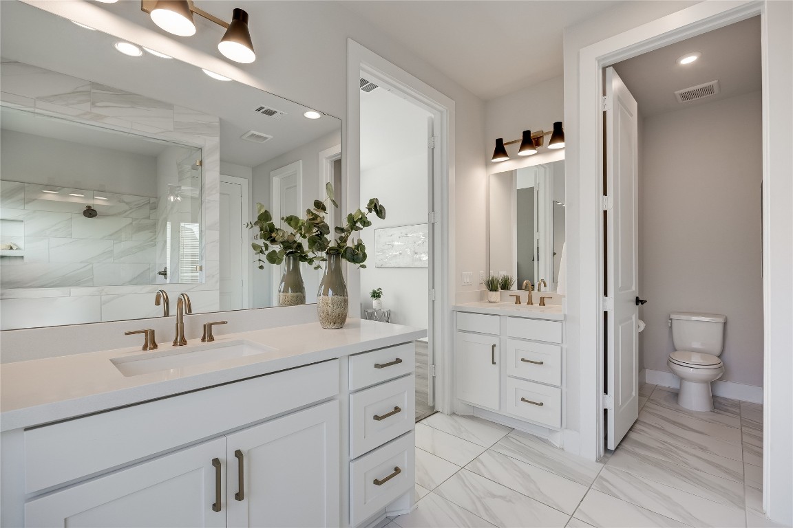 200 Grn Knl Lane Georgetown, TX 78628 - Photo 17 of 32 a bathroom with a granite countertop sink a toilet and a large mirror