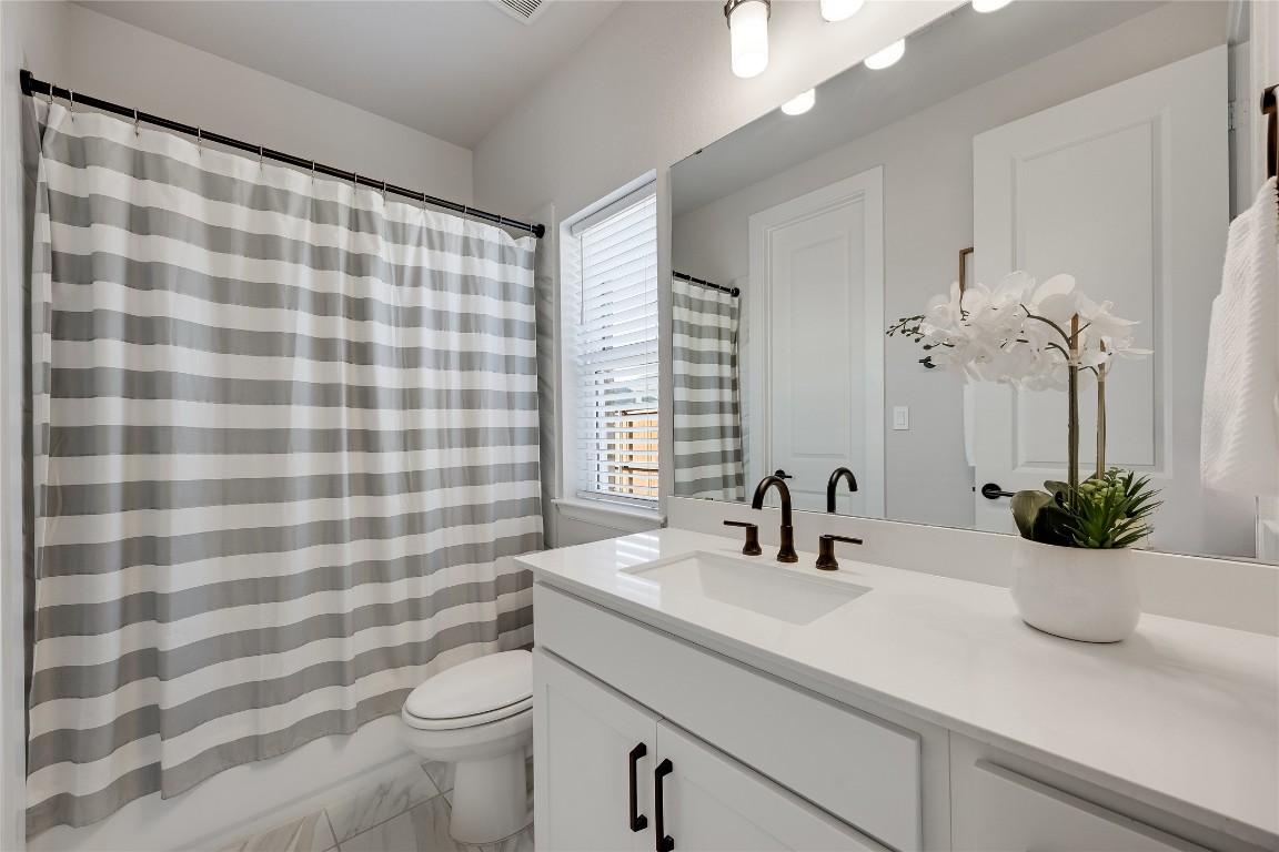 200 Grn Knl Lane Georgetown, TX 78628 - Photo 22 of 32 a bathroom with a sink a toilet and a mirror