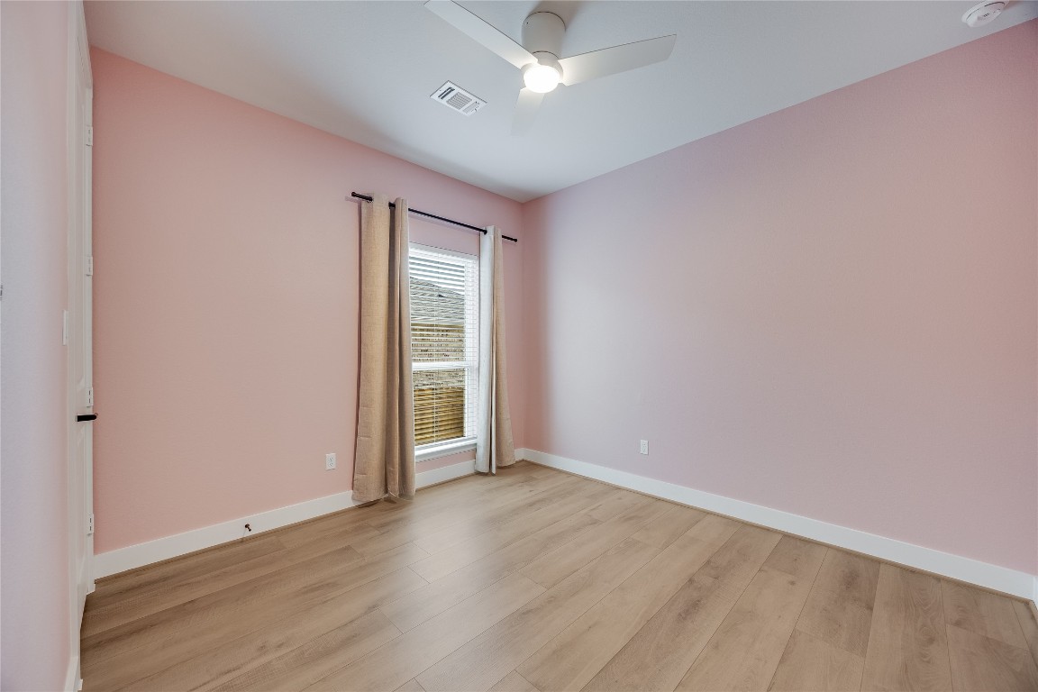 200 Grn Knl Lane Georgetown, TX 78628 - Photo 24 of 32 an empty room with wooden floor and windows