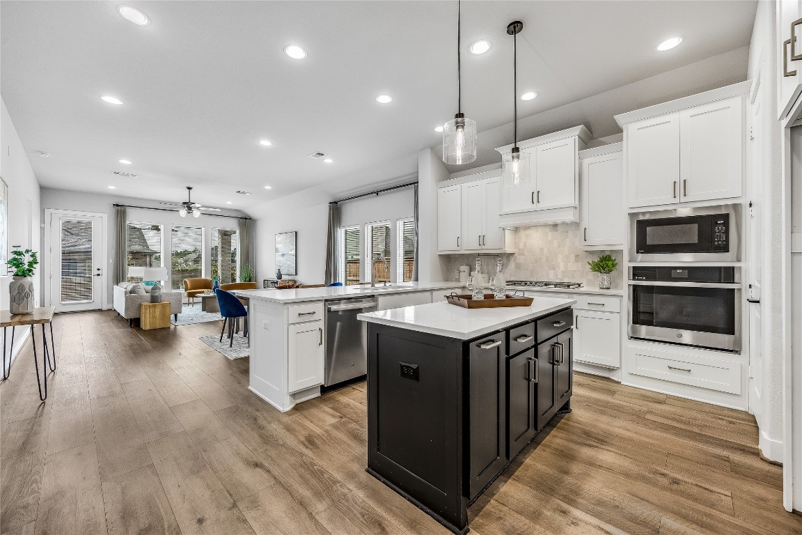 200 Grn Knl Lane Georgetown, TX 78628 - Photo 5 of 32 a kitchen with stove and wooden floor