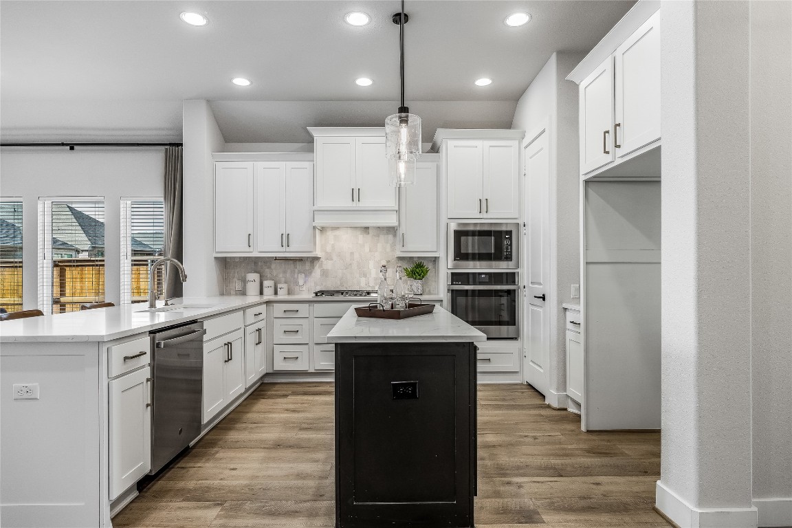 200 Grn Knl Lane Georgetown, TX 78628 - Photo 7 of 32 a kitchen with stainless steel appliances granite countertop a sink stove and refrigerator