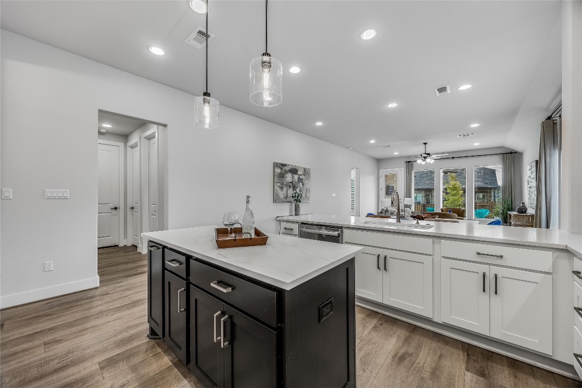 200 Grn Knl Lane Georgetown, TX 78628 - Photo 8 of 32 a kitchen with a sink stove and wooden floor