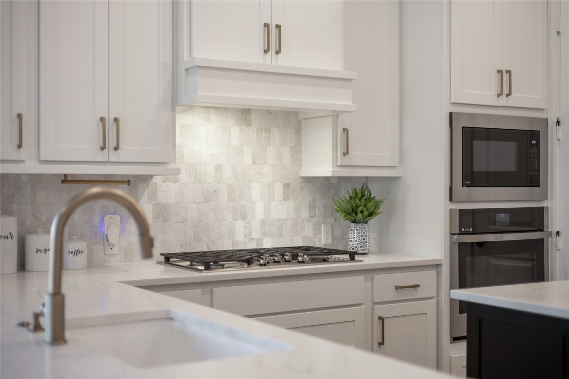 200 Grn Knl Lane Georgetown, TX 78628 - Photo 9 of 32 a kitchen with granite countertop a stove and a white cabinets