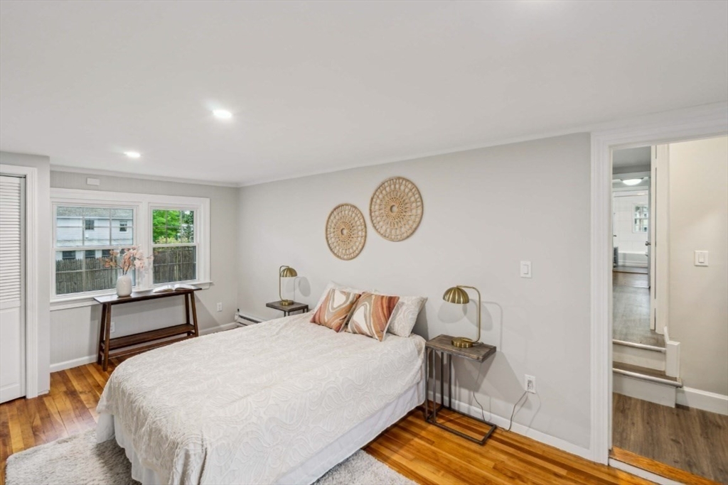 1 Arbor Road North Chelmsford, MA 01863 - Photo 24 of 40 a bedroom with a bed and wooden floor