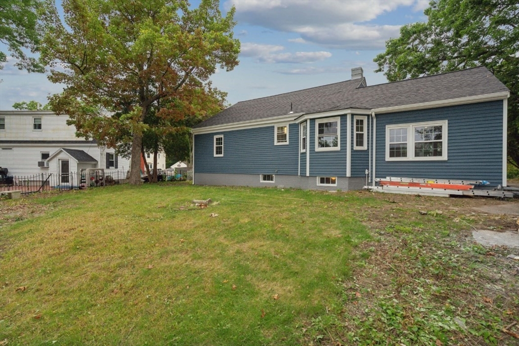 1 Arbor Road North Chelmsford, MA 01863 - Photo 39 of 40 a front view of house with yard and trees in the background