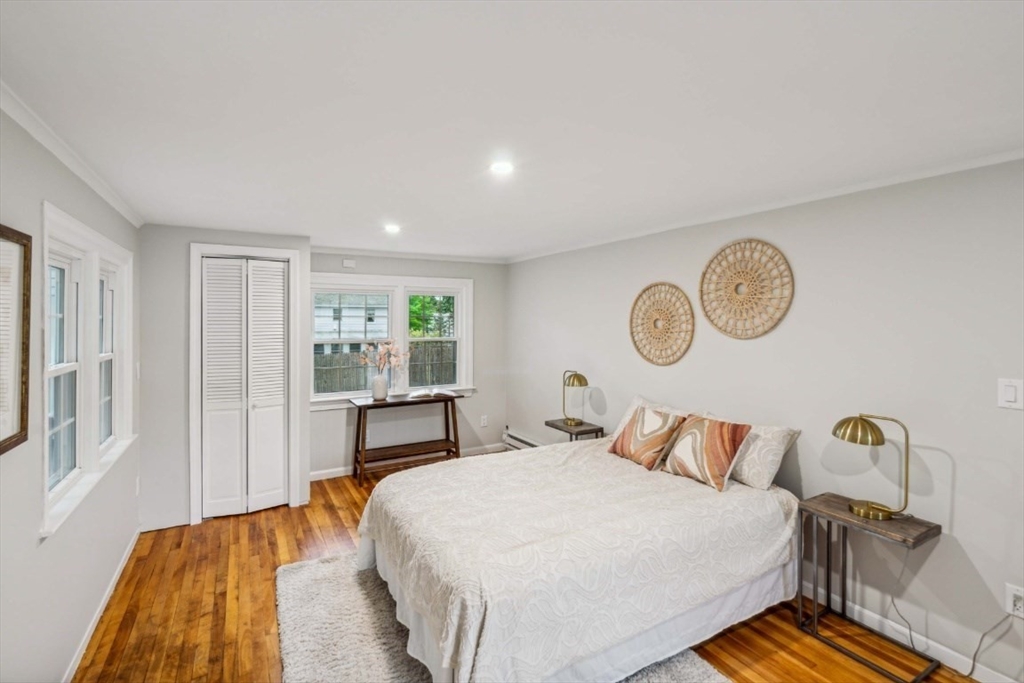 1 Arbor Road North Chelmsford, MA 01863 - Photo 5 of 40 a bedroom with a bed and a chandelier