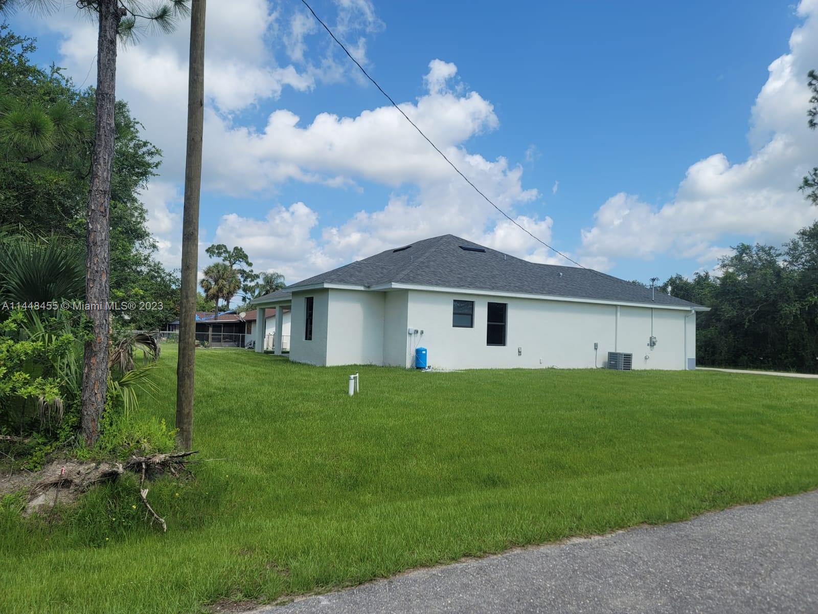 401 West 5th Street, Unit ST Lehigh Acres, FL 33972 - Photo 3 of 10 a front view of a house with a yard